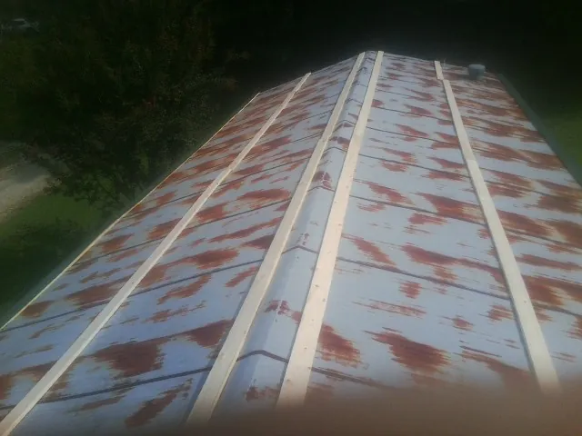 Rusted metal roof panels with new wood purlins before replacement — Storm Damage Roof Repair in Morgan City by Roofing Brothers
